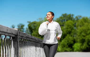 Image showing african american woman running outdoors