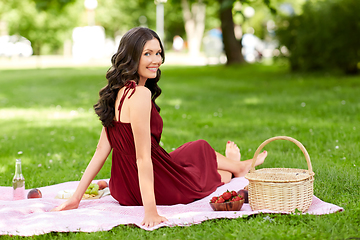 Image showing happy woman with picnic basket at summer park
