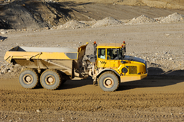 Image showing Yellow dump truck working in gravel pit