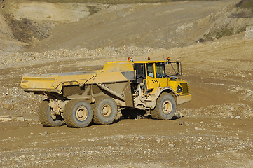 Image showing Yellow dump truck working in gravel pit