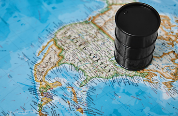 Image showing Oil drum with crude petroleum standing on a map