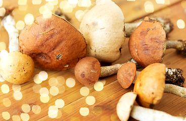 Image showing brown cap boletus mushrooms on wooden background