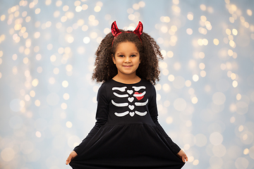 Image showing girl in black dress and devil's horns on halloween