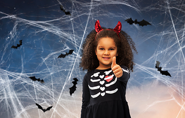 Image showing girl in black dress and devil's horns on halloween