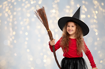 Image showing girl in black witch hat with broom on halloween