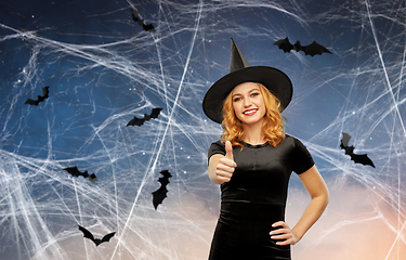 Image showing happy woman in black halloween costume of witch