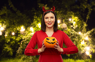 Image showing woman in halloween costume of devil with pumpkin