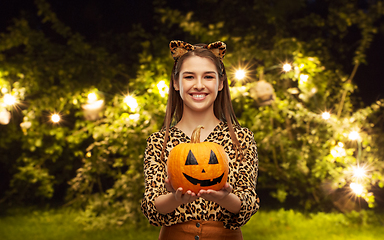 Image showing woman in halloween costume of leopard with pumpkin