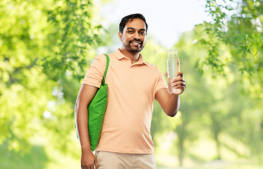 Image showing man with bag for food shopping and glass bottle