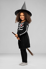 Image showing girl in black witch hat with broom on halloween