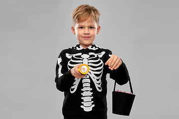 Image showing boy with candies and flashlight on halloween