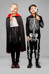 Image showing children in halloween costumes with party props
