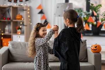 Image showing girls in halloween costumes dancing at home