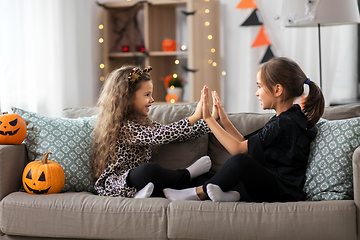Image showing girls in halloween costumes playing game at home