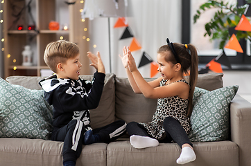 Image showing kids in halloween costumes playing game at home