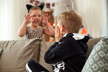 Image showing kids in halloween costumes having fun at home