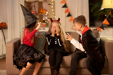 Image showing kids in halloween costumes playing at home