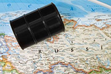 Image showing Oil drum with crude petroleum lying on a map