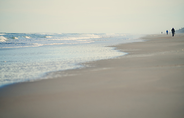 Image showing Incidental people walking along the beach of Atlantic Ocean. USA