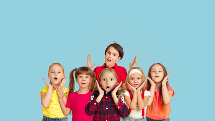 Image showing Portrait of little children gesturing isolated on blue studio background with copyspace