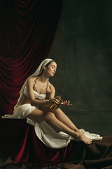 Image showing Modern remake of classical artwork with coronavirus theme - young medieval woman on dark background