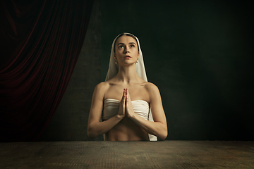 Image showing Modern remake of classical artwork. Young medieval woman on dark background