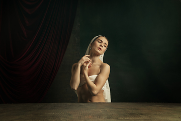 Image showing Modern remake of classical artwork. Young medieval woman on dark background