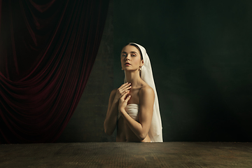 Image showing Modern remake of classical artwork. Young medieval woman on dark background