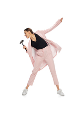 Image showing Happy young woman dancing in stylish clothes or suit, remaking legendary moves of celebrity from culture history