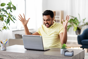 Image showing angry man with laptop working at home office
