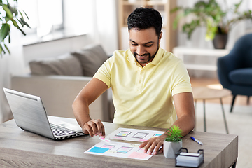 Image showing ui designer working on user interface at home