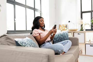 Image showing african american woman with smartphone at home