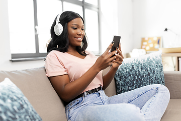 Image showing woman with smartphone listening to music at home