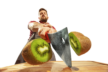 Image showing Amazing caucasian man preparing unbelievable food with action, details and bright emotions, professional cook isolated on white studio background.