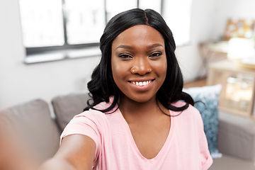 Image showing happy african american woman taking selfie at home