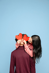 Image showing Beautiful couple in love on blue studio background. Valentine\'s Day, love and emotions concept