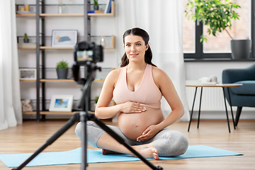 Image showing happy pregnant woman blogger recording yoga video