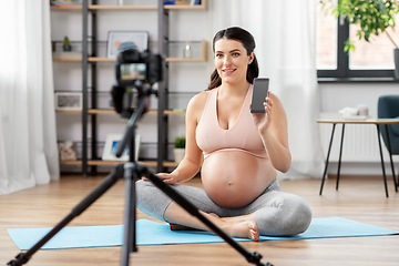 Image showing happy pregnant woman blogger recording yoga video