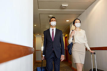 Image showing business team in masks with travel bags at hotel