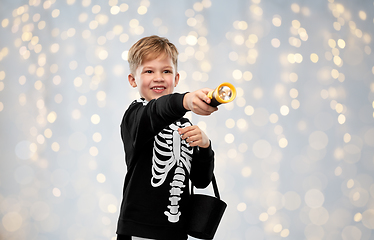 Image showing boy with candies and flashlight on halloween