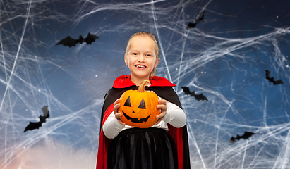 Image showing girl in halloween costume of dracula with pumpkin