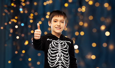 Image showing boy in halloween skeleton costume shows thumbs up