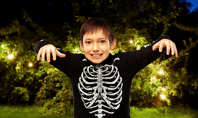 Image showing boy in halloween costume of skeleton frightening
