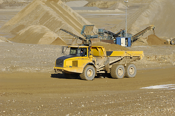 Image showing Yellow dump truck working in gravel pit