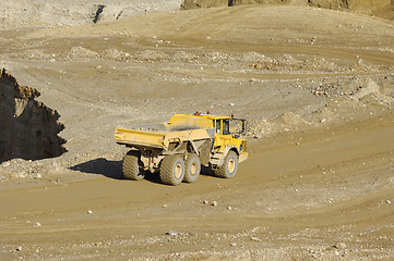 Image showing Yellow dump truck working in gravel pit