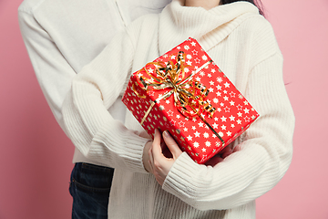 Image showing Close up beautiful couple in love on pink studio background. Valentine\'s Day, love and emotions concept