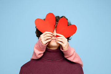 Image showing Beautiful couple in love on blue studio background. Valentine\'s Day, love and emotions concept