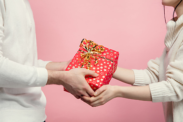 Image showing Close up beautiful couple in love on pink studio background. Valentine\'s Day, love and emotions concept