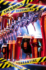 Image showing Glasses of different types of beer at bar with bounding tapes Lockdown, Coronavirus, Quarantine, Warning - closing bars and nightclubs during pandemic