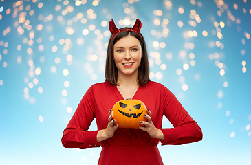 Image showing woman in halloween costume of devil with pumpkin